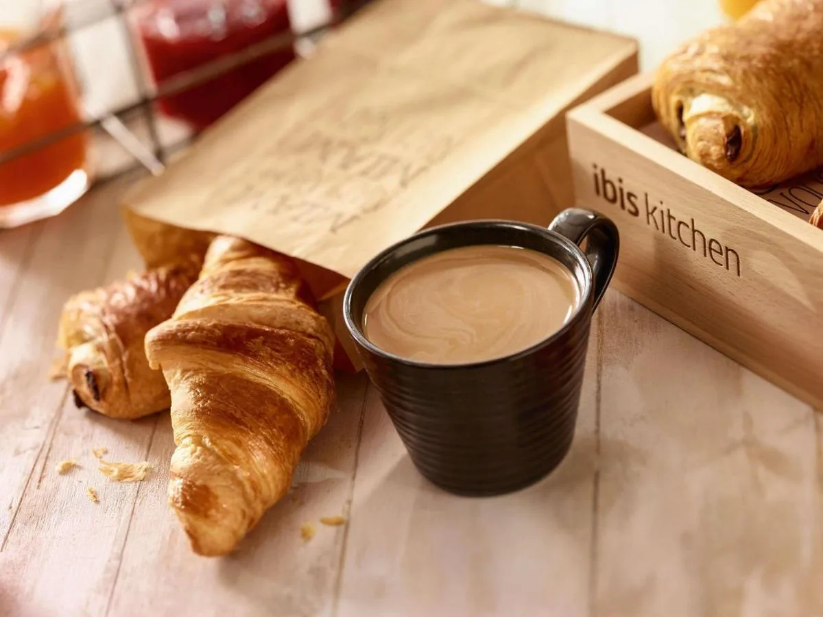 A cup of coffee and croissants on a table at ibis Liverpool Centre Albert Dock – Liverpool One